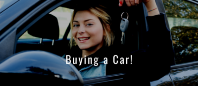 Woman sitting in car smiling and holding up a car key