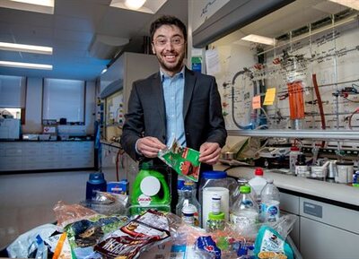 Professor in lab with table full of plastic materials