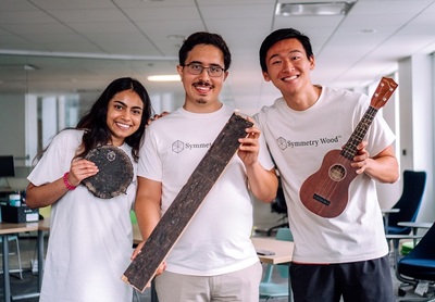 From left: Angie Lewis displays a piece of Pyrus, while Gabe Tavas shows a Pyrus plank and Brian Cheng holds a ukelele with parts made from Pyrus.