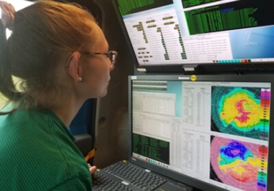 a woman is looking at a radar screen