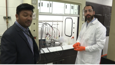 researchers in metal lab