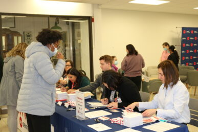 people at a table with papers and pamphlets on it