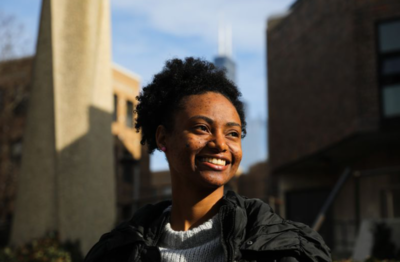 Young black female smiling in front of buildings in Chicago
