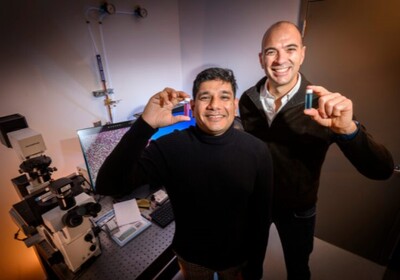 Researcher Indrajit Srivastava, left, and Prof. Viktor Gruev hold vials of new imaging agents developed by their research team that help surgeons to better see cancer tumors