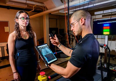 Graduate student Jonathan Cerna monitors heart data from a “smart shirt” that tracks electrical activity as graduate student Laila Shaaban exercises and rests. Researchers are working to develop the technology to make heart-related predictions more widely accessible through the use of wearables. Photo by Fred Zwicky