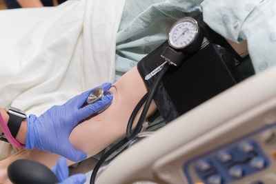 nurse taking vitals on patient