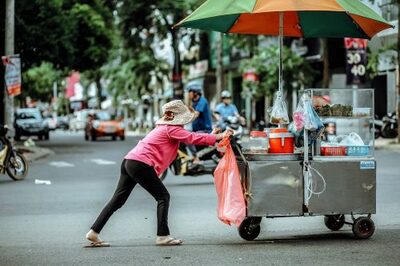 person pushing street vendor food cart