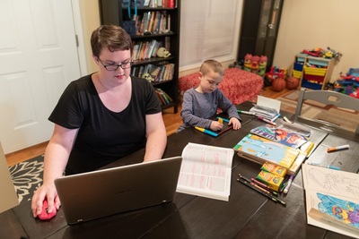 Mom at computer with child at table