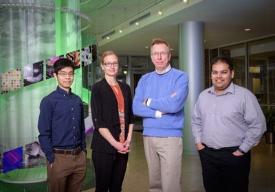four researchers standing, facing the camera