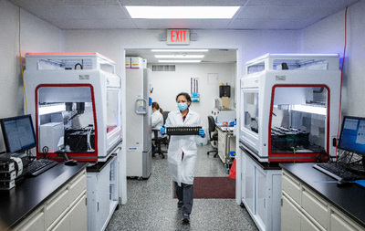 Researcher in SHIELD lab carrying samples