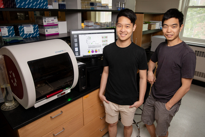 Two Asian males posing in lab